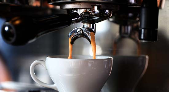 Billede af espressokaffe der brygges på maskine.
